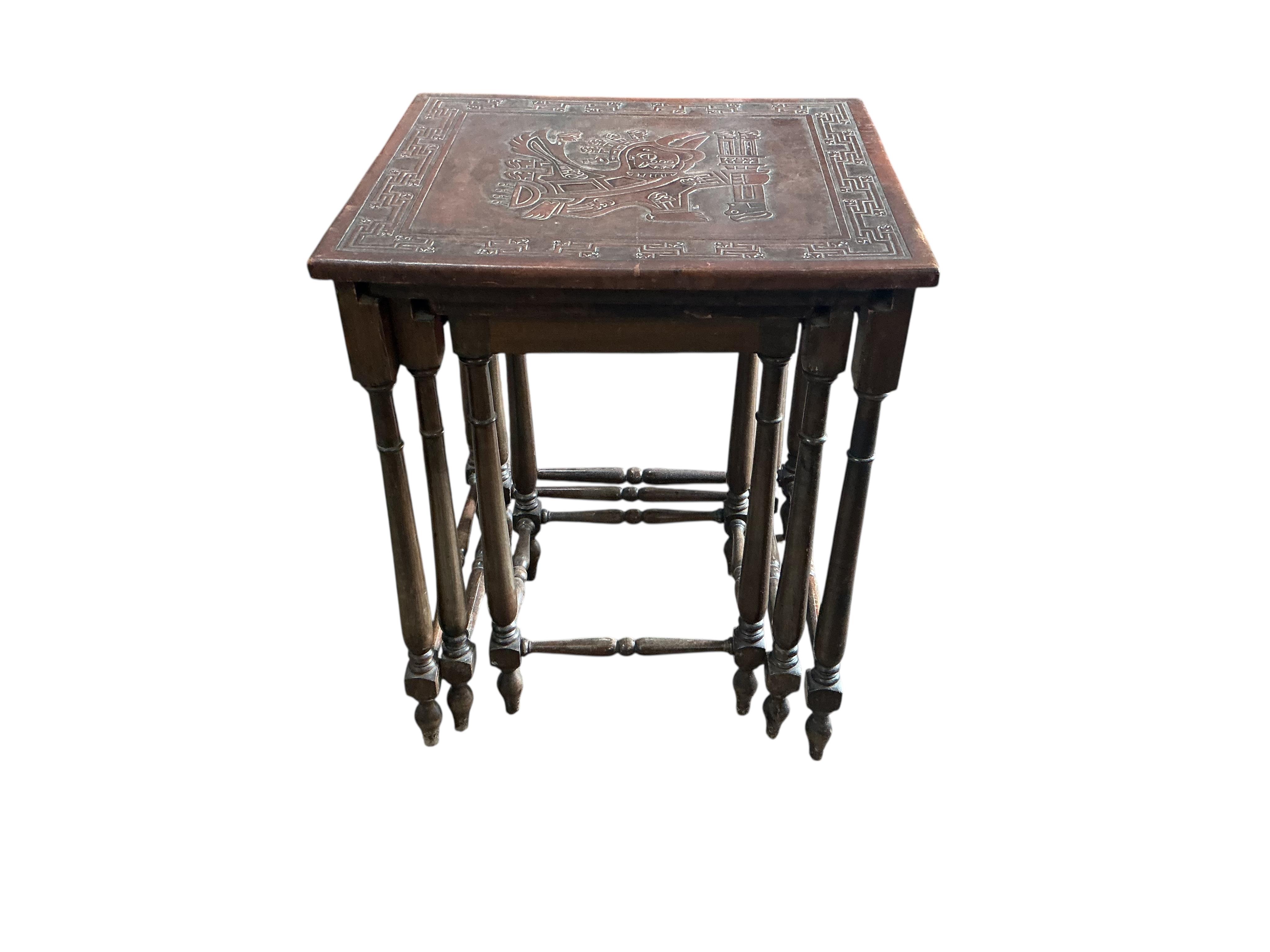 A Peruvian rectangular embossed leather turned wood coffee table, width 128cm, depth 50cm, height 42cm together with a similar nest of tables